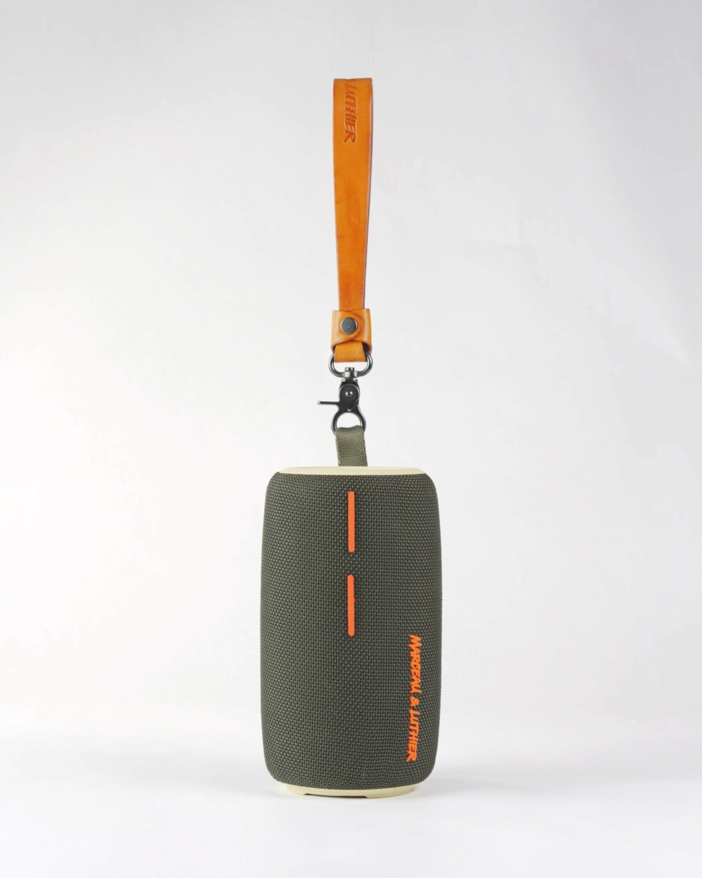 Pigalle portable speaker with its premium tan leather carrying strap extended, showcasing portability and style.