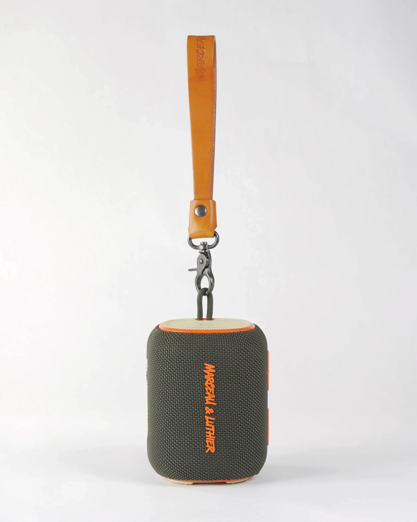 Front view of the Belleville portable speaker showing the high-quality tan leather handle and vibrant orange logo.