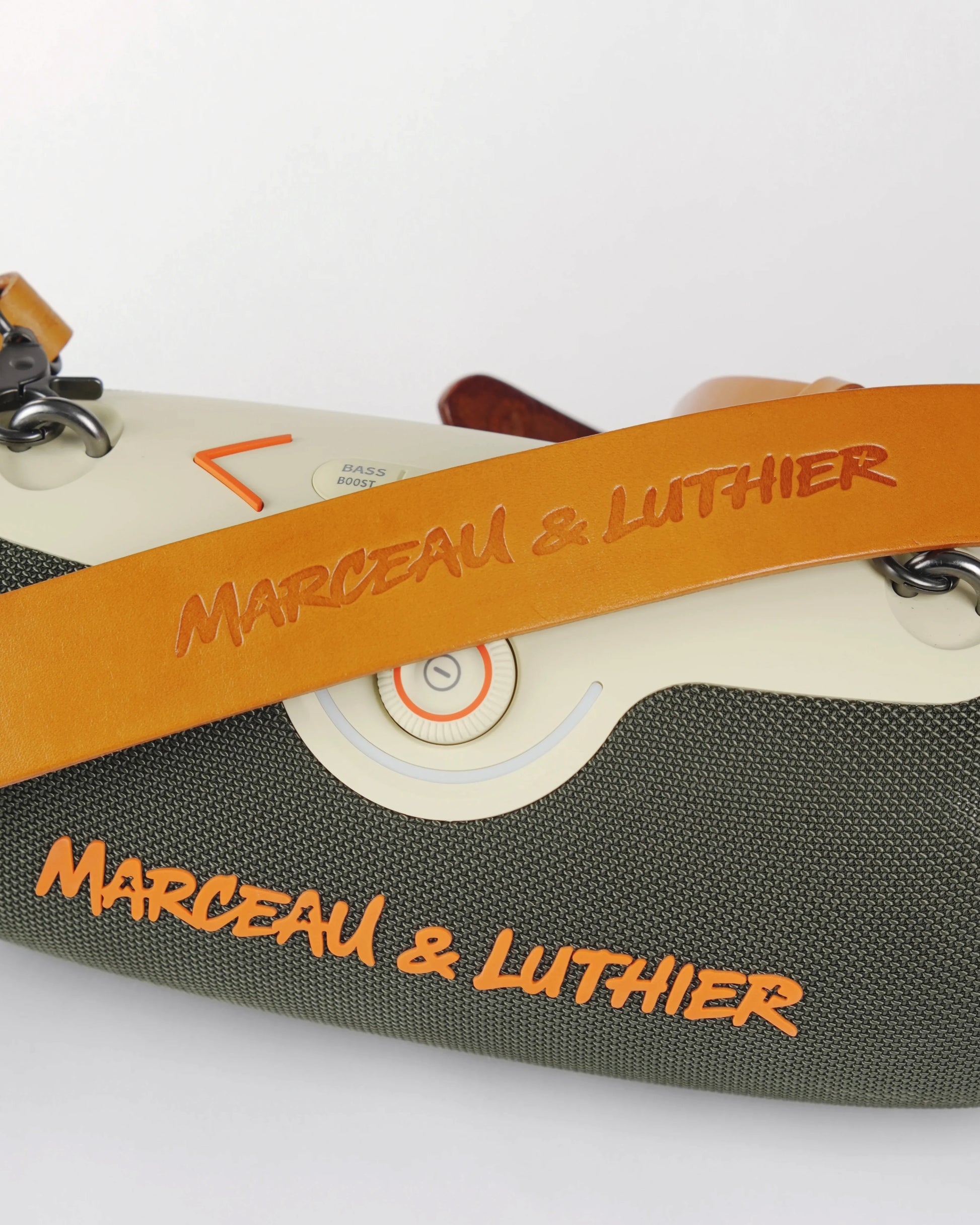 Close-up of the premium brown leather strap embossed with the Marceau & Luthier logo on the Rive Droite speaker.
